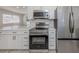 Modern kitchen with stainless steel appliances and white cabinets at 506 Buena Vista Dr, Nokomis, FL 34275