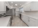 Well-lit kitchen with stainless steel appliances, white cabinetry and countertops providing a clean modern feel at 506 Buena Vista Dr, Nokomis, FL 34275