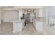 Modern kitchen with stainless steel appliances, white cabinets, a breakfast bar and ample counter space at 506 Buena Vista Dr, Nokomis, FL 34275