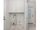 Clean laundry room with storage and tile floors; conveniently located near the entrance, providing practicality at 506 Buena Vista Dr, Nokomis, FL 34275