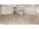 Bright living room featuring tile flooring that extends into an open-concept kitchen area, perfect for gatherings at 506 Buena Vista Dr, Nokomis, FL 34275
