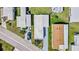 Overhead view of a neat single-story home with a long driveway and palm trees at 508 Blackburn Blvd, North Port, FL 34287