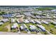 A wide aerial shot features a residential community along winding waterways, showcasing the diverse architectural styles and landscaping at 508 Blackburn Blvd, North Port, FL 34287