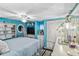 Bright bedroom with blue walls, built-in storage, and a comfortable bed at 508 Blackburn Blvd, North Port, FL 34287
