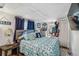 Comfortable bedroom with a patterned bedspread, side table, and ample closet space at 508 Blackburn Blvd, North Port, FL 34287