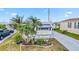Attractive single-story home with a blue-tinted driveway, palm trees, and awnings at 508 Blackburn Blvd, North Port, FL 34287