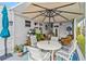 Outdoor patio features a dining table set with cushioned chairs and a large umbrella, perfect for relaxing or dining at 508 Blackburn Blvd, North Port, FL 34287