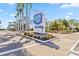 Harbor Cove waterfront community sign with lush landscaping and palm tree-lined street at 508 Blackburn Blvd, North Port, FL 34287