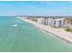 Scenic aerial view of pristine beachfront condos, showcasing the stunning coastline at 516 Dante St, Venice, FL 34285