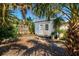 Backyard shed with double doors, surrounded by lush greenery and plants, enhancing the serene outdoor space at 516 Dante St, Venice, FL 34285