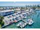 Aerial view of a marina with boats, docks, and a restaurant and car parking lot at 632 Valencia Rd, Venice, FL 34285