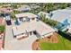 Aerial view of a home boasting mature landscaping, a large driveway and well-maintained lawn at 632 Valencia Rd, Venice, FL 34285