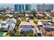 An aerial view of a beautiful property with a private pool, lush landscaping, and clear sightlines to the beach at 632 Valencia Rd, Venice, FL 34285