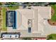 Top-down view of a property with an enclosed pool, a covered lanai, mature landscaping, and a large driveway at 632 Valencia Rd, Venice, FL 34285
