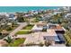 Beautiful aerial view of a residential neighborhood near the ocean featuring palm trees and manicured lawns at 632 Valencia Rd, Venice, FL 34285