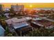 Aerial view of a home near the beach featuring lush greenery, with ocean views and clear skies during sunset at 632 Valencia Rd, Venice, FL 34285