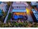 Aerial view of a home featuring an enclosed pool, outdoor seating, well-maintained lawn, and privacy fence at 632 Valencia Rd, Venice, FL 34285