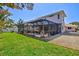 Expansive backyard with screened in patio and lush greenery, ideal for relaxation and recreation at 632 Valencia Rd, Venice, FL 34285