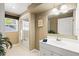 Bright bathroom featuring a shower and tub combo, white sink, and tiled floor at 632 Valencia Rd, Venice, FL 34285