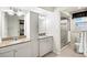 Bathroom featuring double sinks with granite counters, vanity storage and a glass enclosed shower at 632 Valencia Rd, Venice, FL 34285