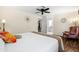 Bedroom boasts hardwood floors, a ceiling fan, and a cozy chair by the window, creating a relaxing space at 632 Valencia Rd, Venice, FL 34285