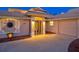 Well-lit front entrance with glass front door, desert landscaping, and automatic two car garage at 632 Valencia Rd, Venice, FL 34285
