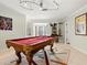 Spacious game room featuring a pool table, ample lighting, and stylish decor at 632 Valencia Rd, Venice, FL 34285