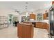 Open kitchen with a center island, stainless steel appliances, and dining area with outdoor view at 632 Valencia Rd, Venice, FL 34285