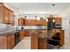 Modern kitchen featuring dark appliances, granite countertops, and ample cabinet space at 632 Valencia Rd, Venice, FL 34285