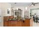 Beautiful kitchen island with seating and views of the home's open-concept living spaces at 632 Valencia Rd, Venice, FL 34285