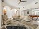 Large living area with high ceilings, neutral colors, and seamless access to the game room at 632 Valencia Rd, Venice, FL 34285