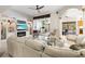 Bright living room with built-ins, fireplace, and sliding glass doors to the outdoor living area at 632 Valencia Rd, Venice, FL 34285