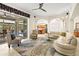 Spacious living room featuring a large sectional sofa, stylish rug, and view of the kitchen at 632 Valencia Rd, Venice, FL 34285