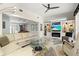 Comfortable living space with built-in shelving, a fireplace, and access to the game room at 632 Valencia Rd, Venice, FL 34285