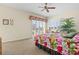 Light-filled main bedroom featuring a floral bedspread, shuttered windows, and view of balcony with natural light at 632 Valencia Rd, Venice, FL 34285