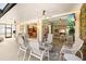 Comfortable covered patio area with ceiling fans and outdoor furniture, with a glimpse into the home's interior at 632 Valencia Rd, Venice, FL 34285