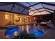 Backyard view of pool with hot tub, fire pit, and covered patio near a luxury RV at 632 Valencia Rd, Venice, FL 34285