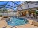 Stunning in-ground pool and spa in a screened enclosure, surrounded by patio seating at 632 Valencia Rd, Venice, FL 34285