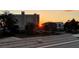 Rooftop view with clear skies overlooking palm trees, nearby buildings, and a vivid sunset at 632 Valencia Rd, Venice, FL 34285