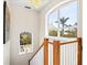 Bright staircase with large arched windows providing natural light and exterior views of the landscape at 632 Valencia Rd, Venice, FL 34285
