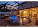 Gorgeous screened-in pool with water features, fire pit, and covered patio at 632 Valencia Rd, Venice, FL 34285