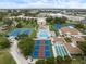 Aerial view of community featuring a pool, tennis courts, and manicured grounds at 652 Bird Bay W Dr # 73, Venice, FL 34285