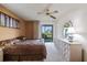 Serene main bedroom with modern furnishings, ceiling fan, and sliding glass doors leading to the backyard at 652 Bird Bay W Dr # 73, Venice, FL 34285