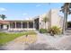Exterior of home featuring screened porch, stucco facade, and tropical landscaping at 718 Golden Beach Blvd # 2, Venice, FL 34285