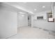 Bright kitchen space with white cabinets, stainless microwave and tile flooring, ready for customization at 718 Golden Beach Blvd # 2, Venice, FL 34285