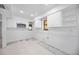 Bright kitchen space with white cabinets, stainless microwave and tile flooring, ready for customization at 718 Golden Beach Blvd # 2, Venice, FL 34285