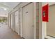 Hallway with storage units and a fire extinguisher for safety and convenience at 748 White Pine Tree Rd # 204, Venice, FL 34285