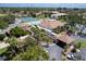 Aerial view of Bird Bay Village shows the pool, tennis courts, and clubhouse at 760 Bird Bay Way # 101, Venice, FL 34285