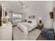 Cozy bedroom featuring a neutral color scheme, vaulted ceiling, and bright window at 803 Montrose Dr # 202, Venice, FL 34293