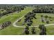 Aerial view of a lush green golf course featuring mature palm trees and manicured fairways at 803 Montrose Dr # 202, Venice, FL 34293